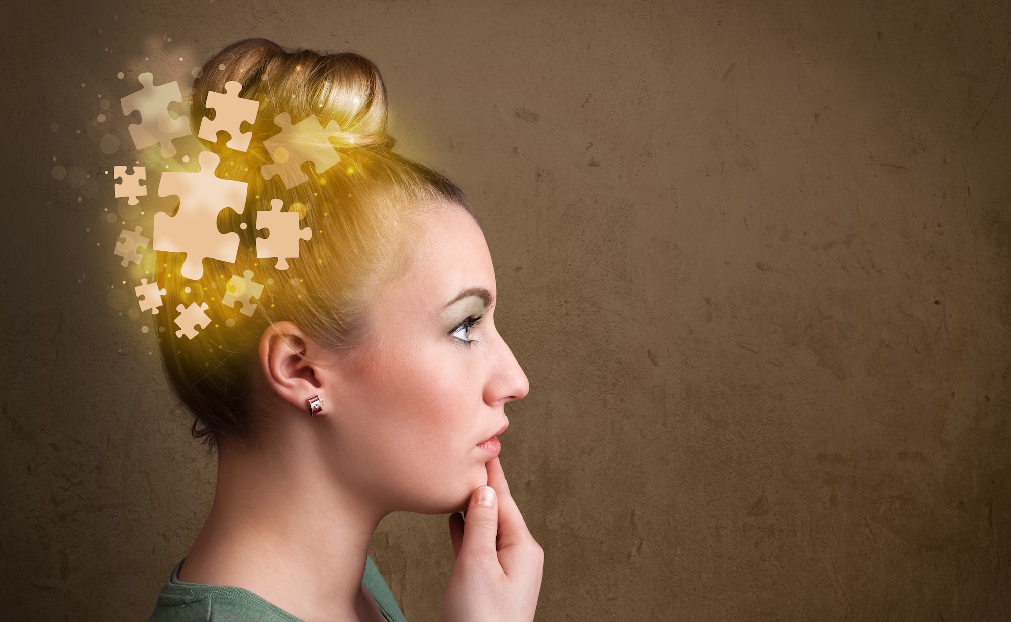 Young person thinking with glowing puzzle mind