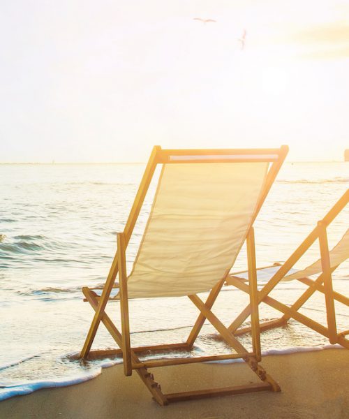Background with couple of deck chairs at sunset, Travel concept, Summer background