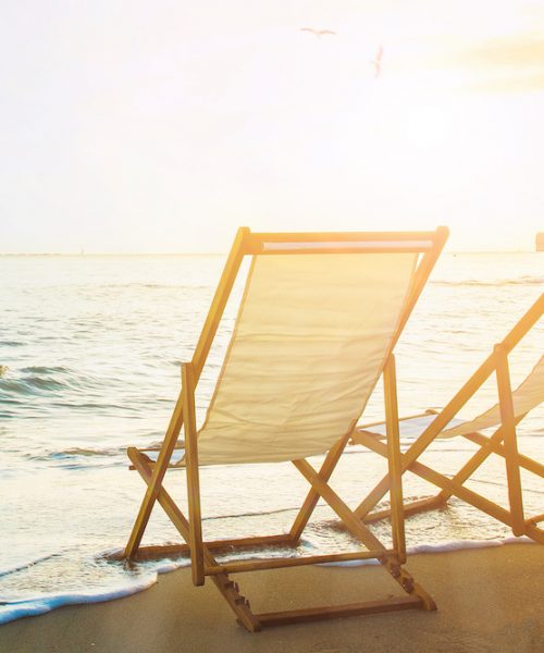 Background with couple of deck chairs at sunset, Travel concept, Summer background