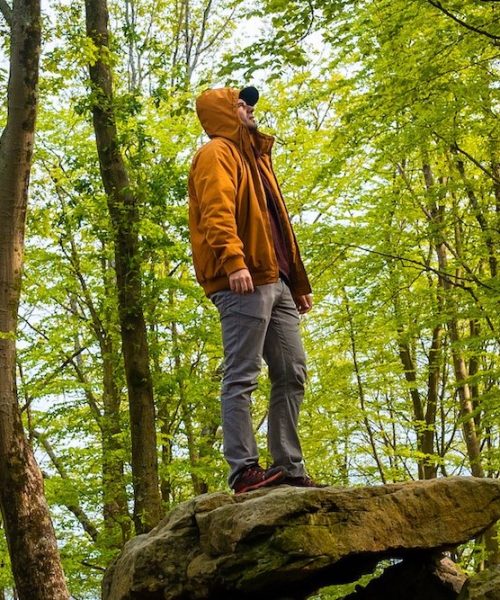 A man on top of the Aitzetako Txabala Dolmen in the Basque Country in spring. Errenteria, Gipuzkoa